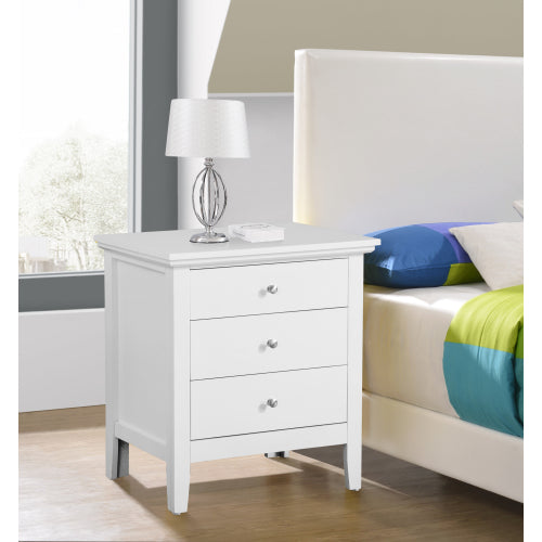 White nightstand with three drawers next to a bed with colorful bedding.