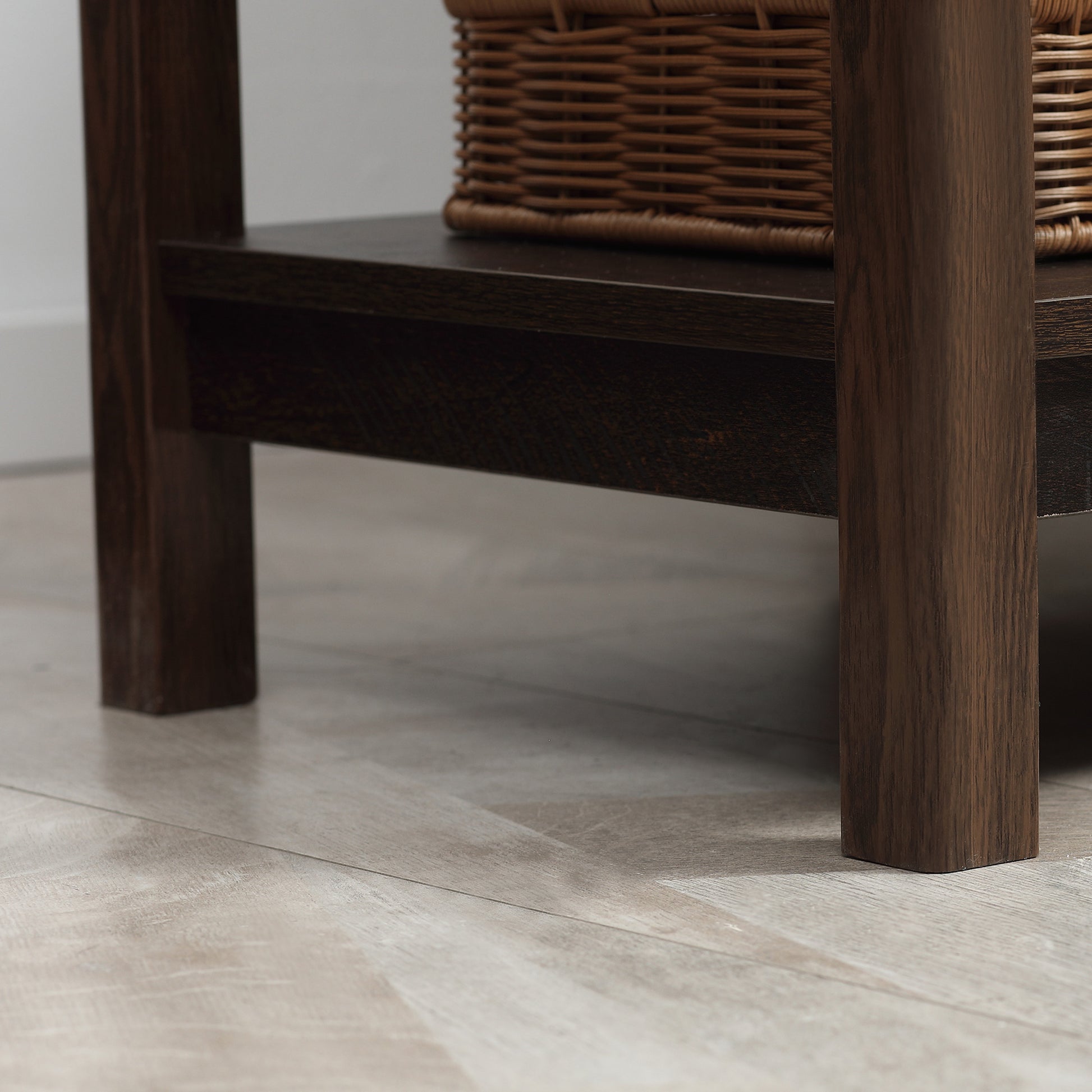 Wooden bench with wicker seat on a tiled floor