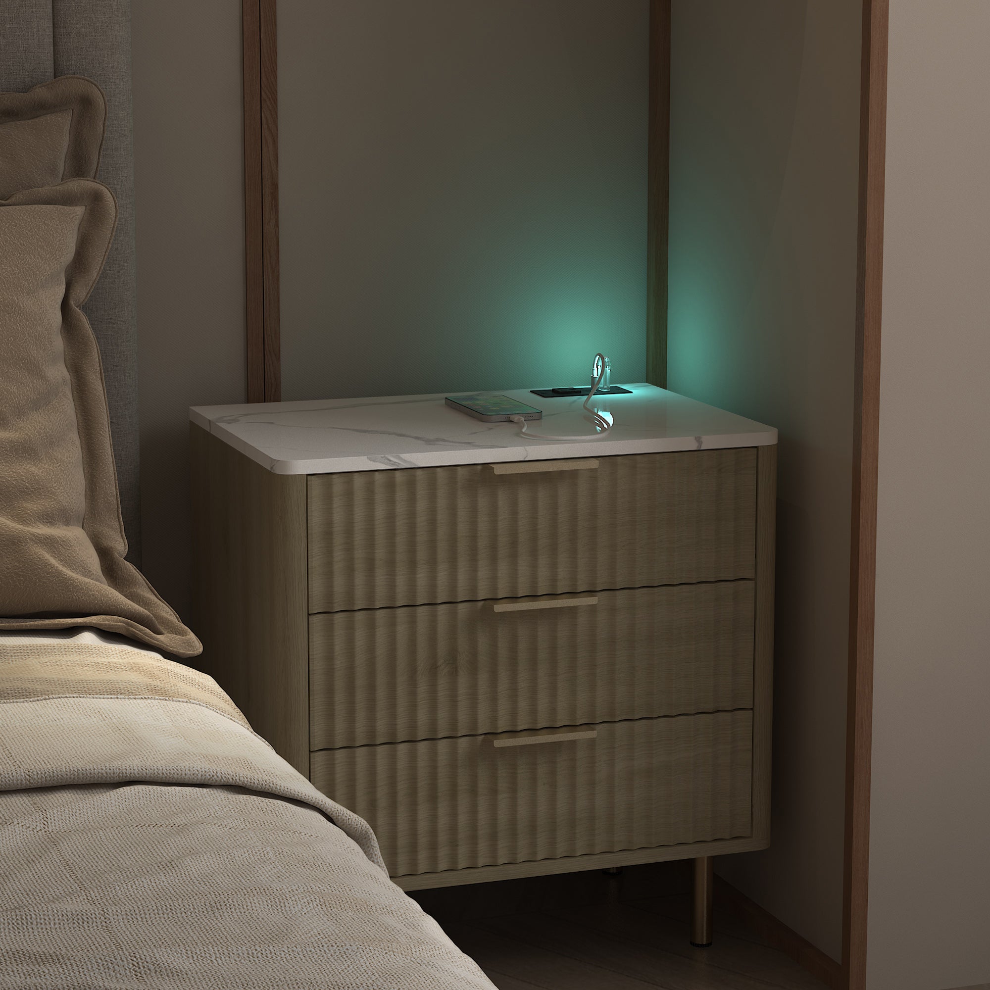 Bedside table with a laptop on a bed in a dimly lit room