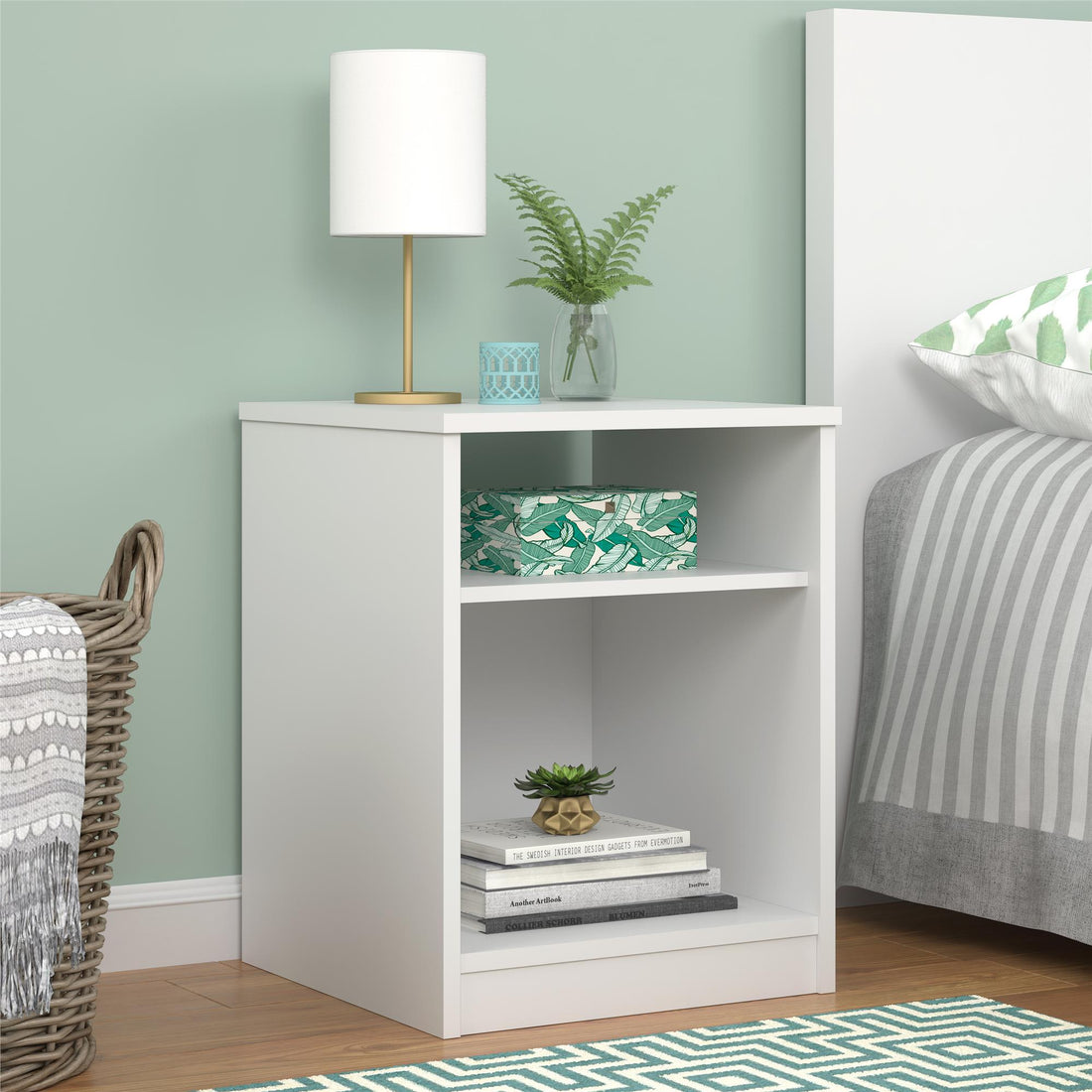 White nightstand with decorative items in a bedroom setting