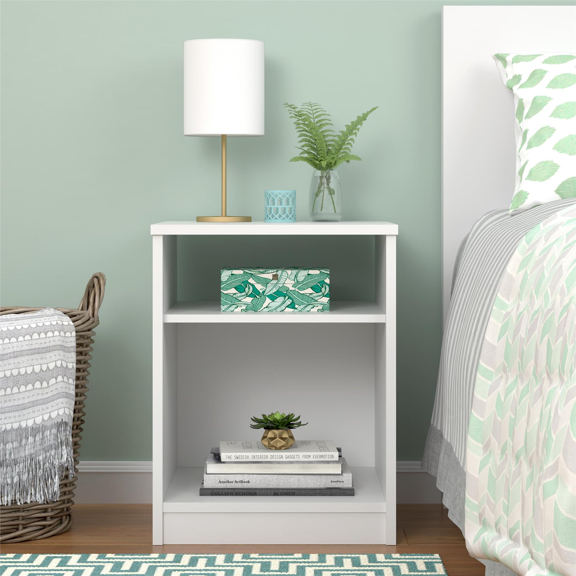 White nightstand with decorative items in a bedroom setting