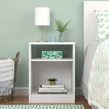 White nightstand with decorative items in a bedroom setting