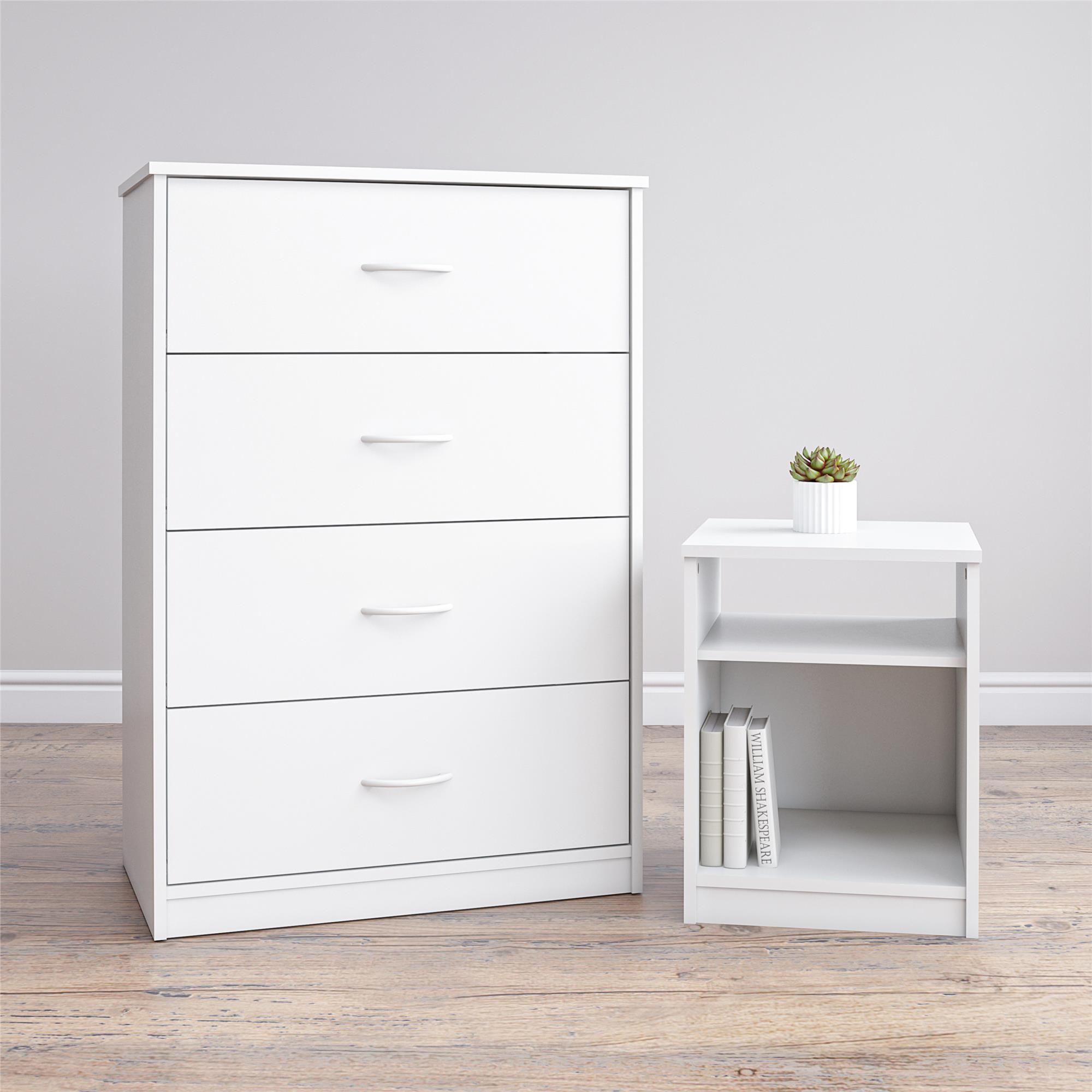 White dresser with multiple drawers next to a white side table with a plant on a wooden floor.