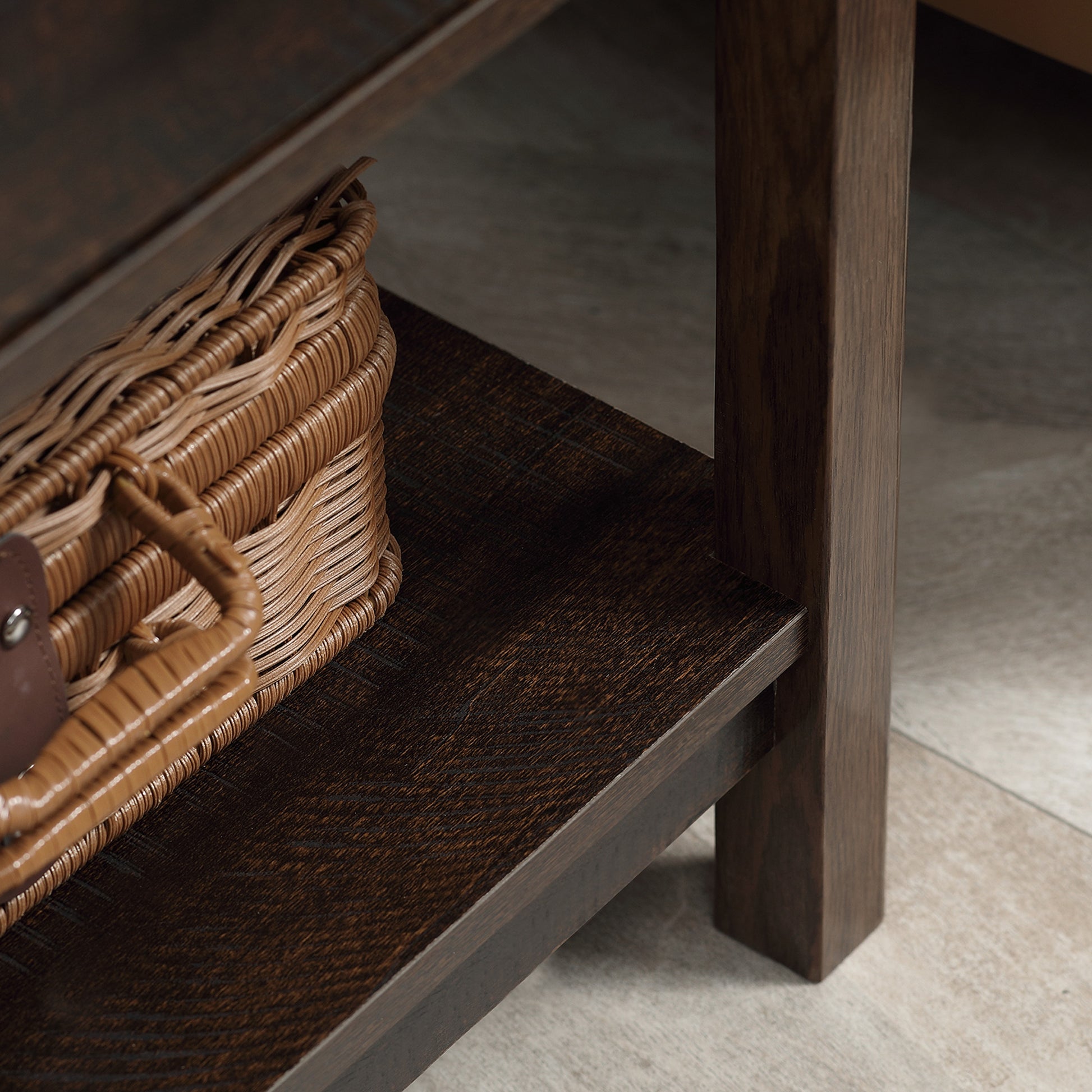 Wooden shelf with a wicker basket on a wooden floor.