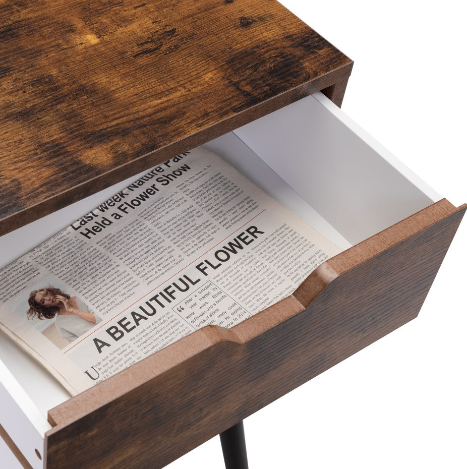 Wooden drawer with an open newspaper inside, featuring a headline about a flower show.
